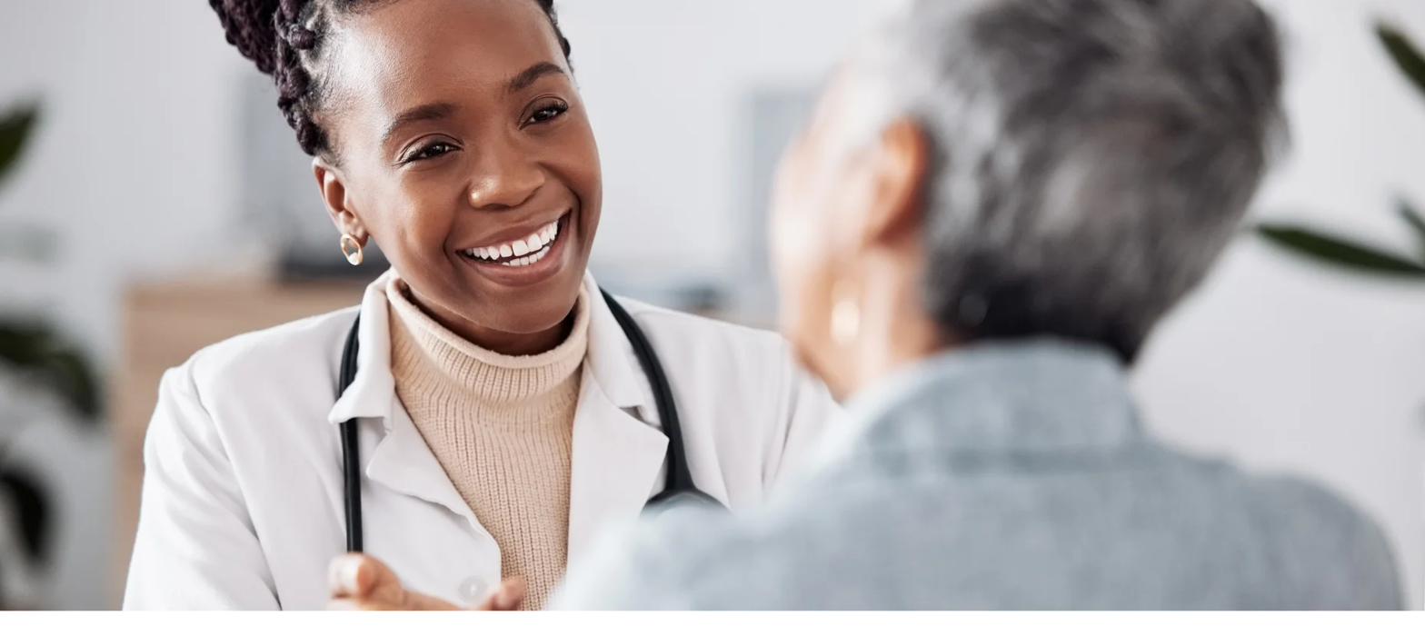 Compassionate physician smiling warmly with a patient
