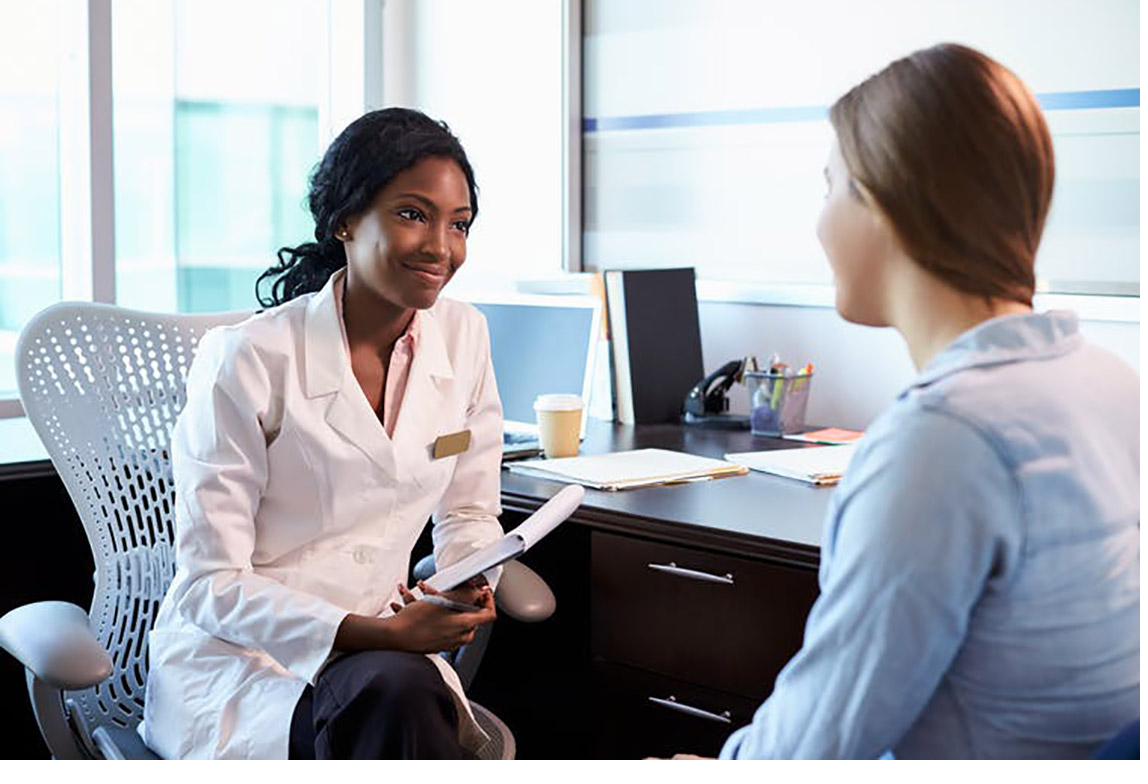 Physician in a clinical conversation with a patient