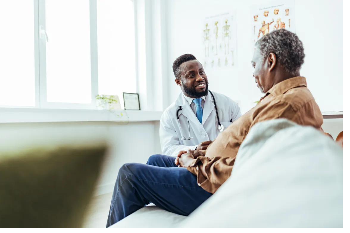Physician consulting with an older patient in a clinical setting